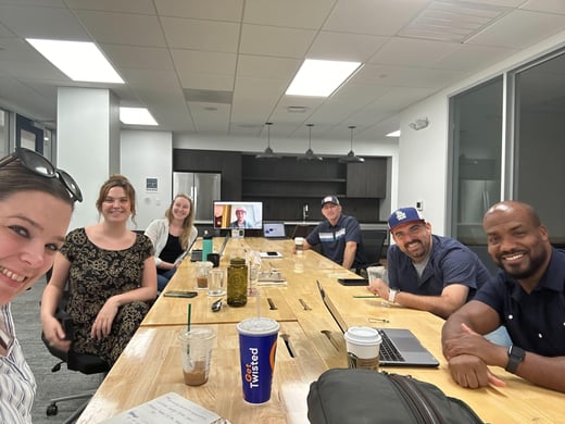 Magazine Jukebox team members sitting at a conference table in Norfolk, VA